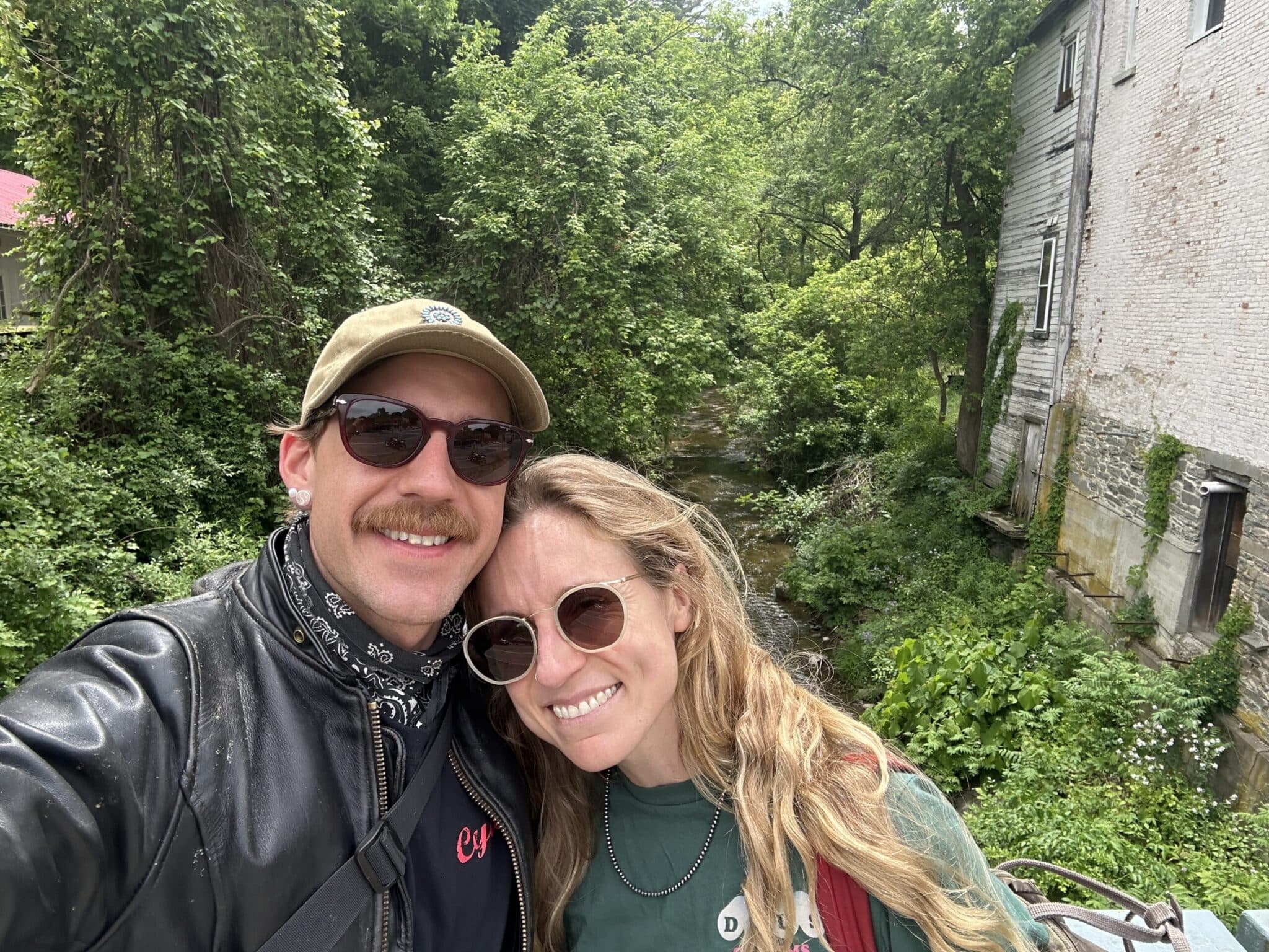 Couple taking a selfie beside an old stone mill in the Southern Finger Lakes
