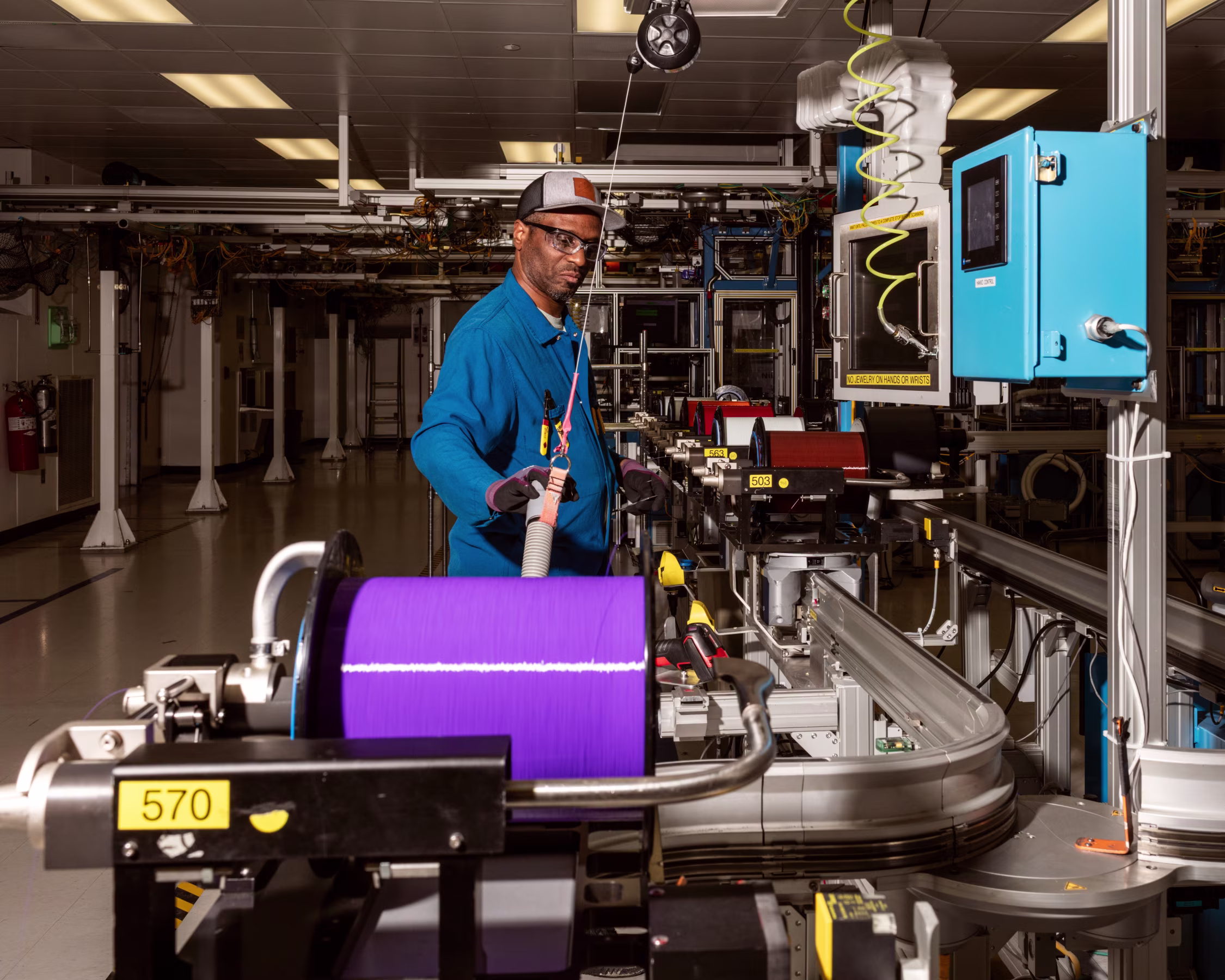 Technician monitoring an automated production line in a manufacturing facility